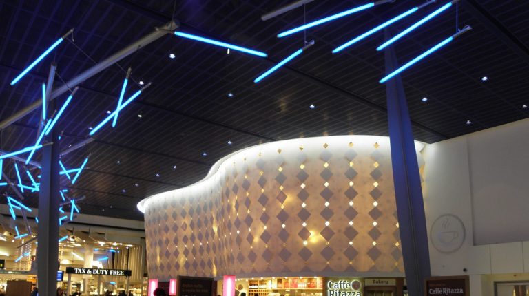 Modern building exterior with LED illuminated curves and blue LED ceiling lights.