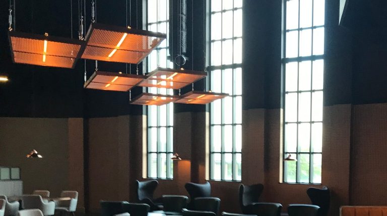 Spacious interior with large windows, LED pendant lights, and stylish seating.